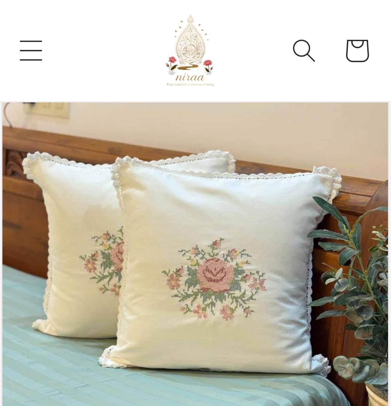 Floral embroidered pillows on a bed
