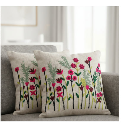 Floral embroidered cushions on a sofa in a living room setting